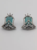 Aqua-blue statement stud earrings with rhodium finish, marquise-cut zircon clusters, and geometric design