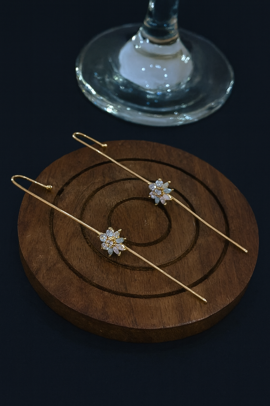 Two gold threader studs with floral ends