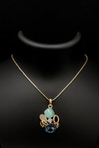 Necklace with a pendant featuring blue and green stones