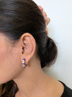 Viola Bloom Huggie Hoops – violet enamel hoops with white daisy and gold details