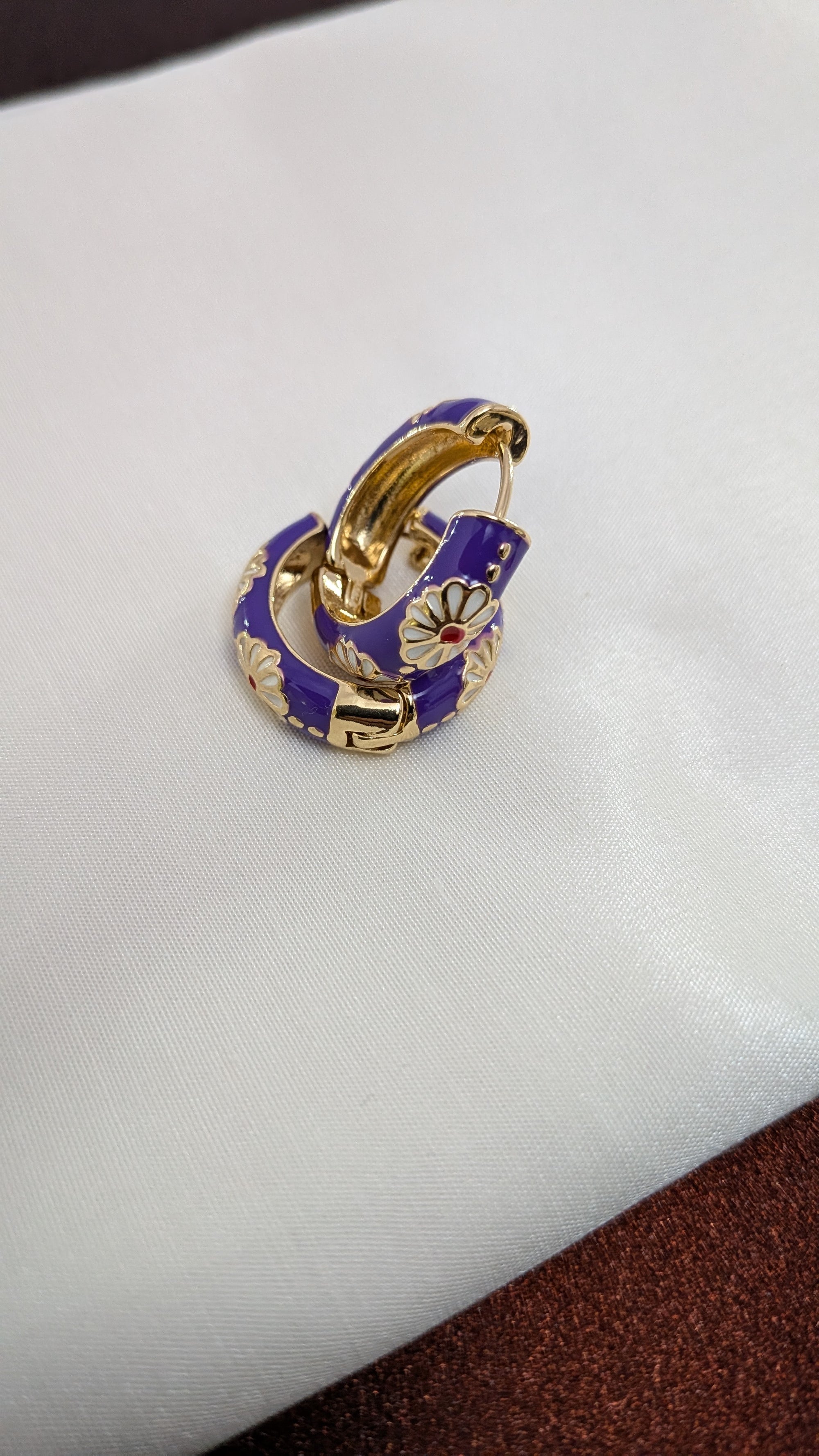 Viola Bloom Huggie Hoops – violet enamel hoops with white daisy and gold details