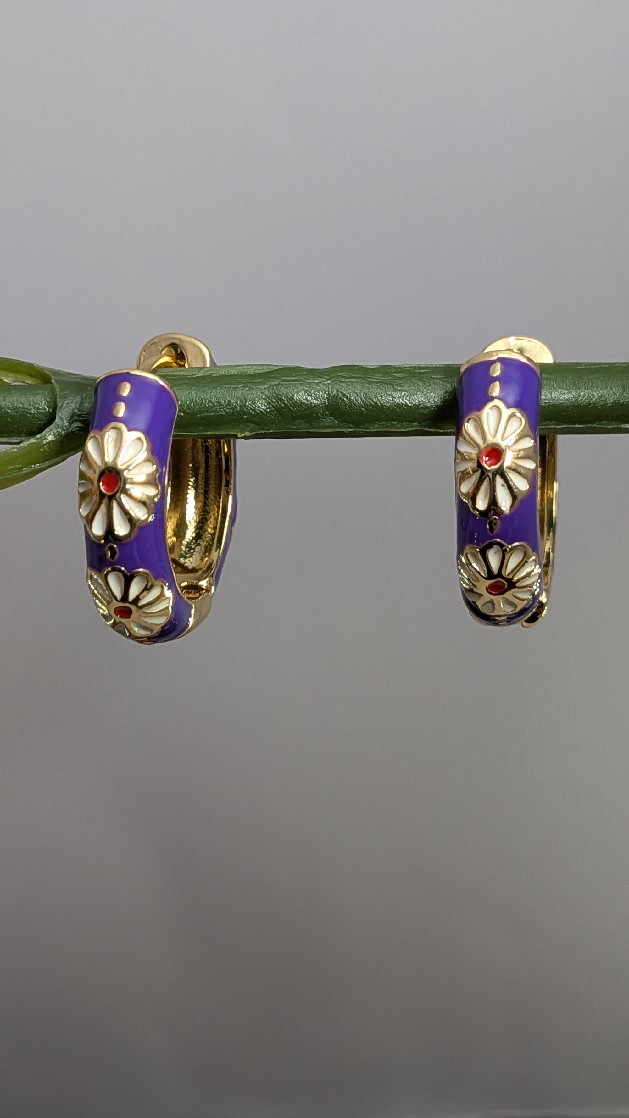 Viola Bloom Huggie Hoops – violet enamel hoops with white daisy and gold details