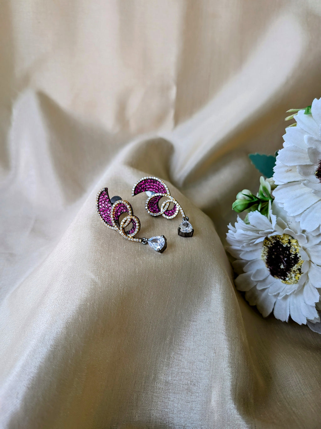 Rust Flame Swirl Drops – fiery swirl earrings with orange pavé and teardrop crystal