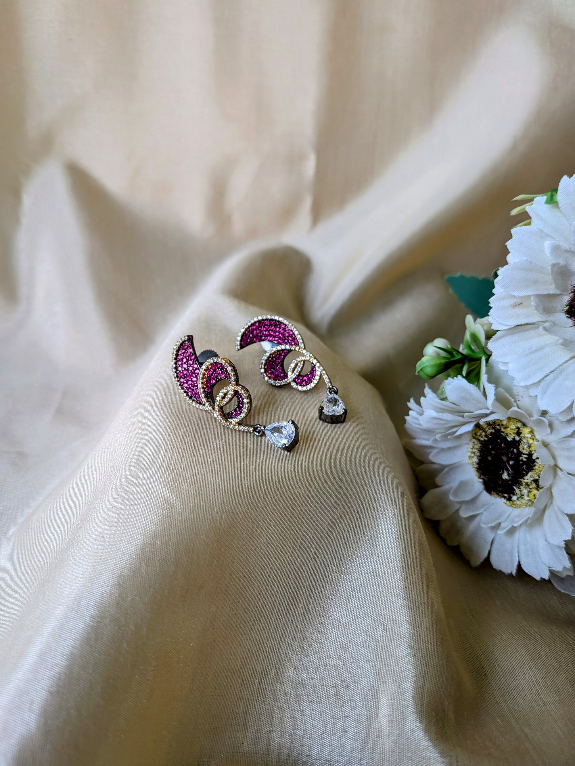 Rust Flame Swirl Drops – fiery swirl earrings with orange pavé and teardrop crystal