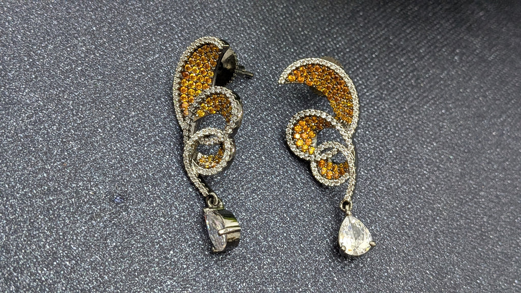 Rust Flame Swirl Drops – fiery swirl earrings with orange pavé and teardrop crystal