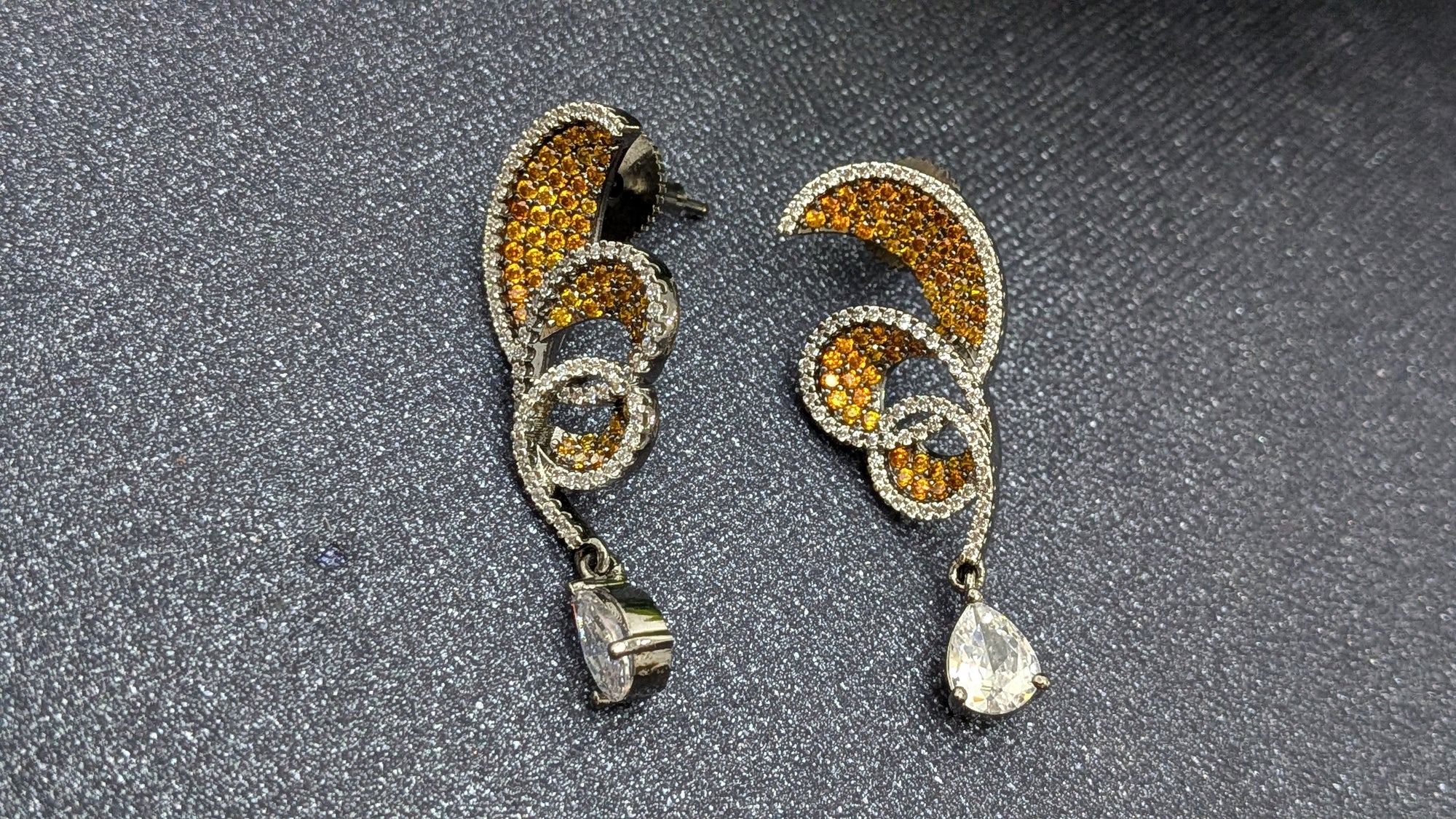 Rust Flame Swirl Drops – fiery swirl earrings with orange pavé and teardrop crystal