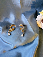 Rust Flame Swirl Drops – fiery swirl earrings with orange pavé and teardrop crystal