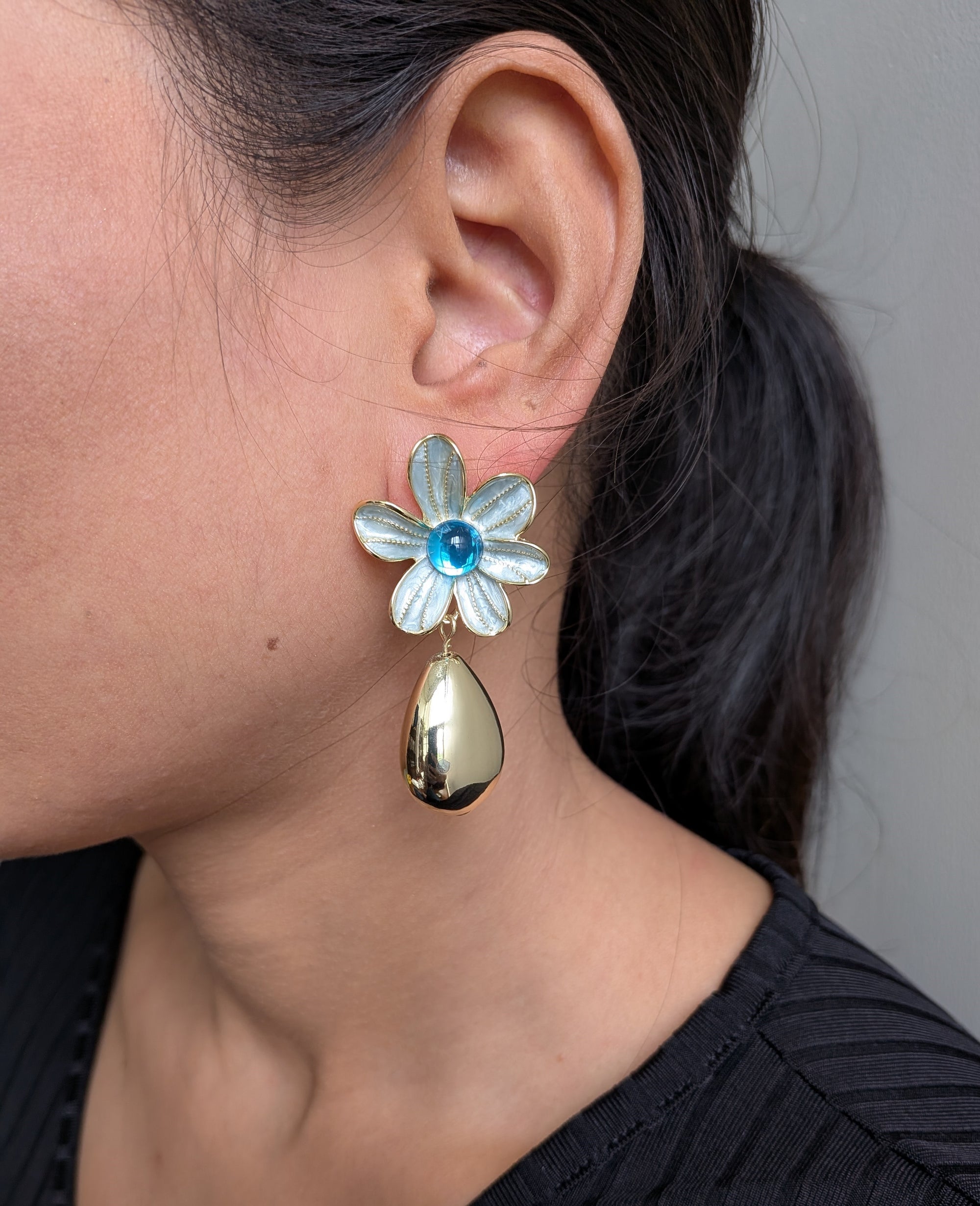 AzurePetal Bloom Drops – pearlescent petal earrings with blue gem and gold-tone droplet charms
