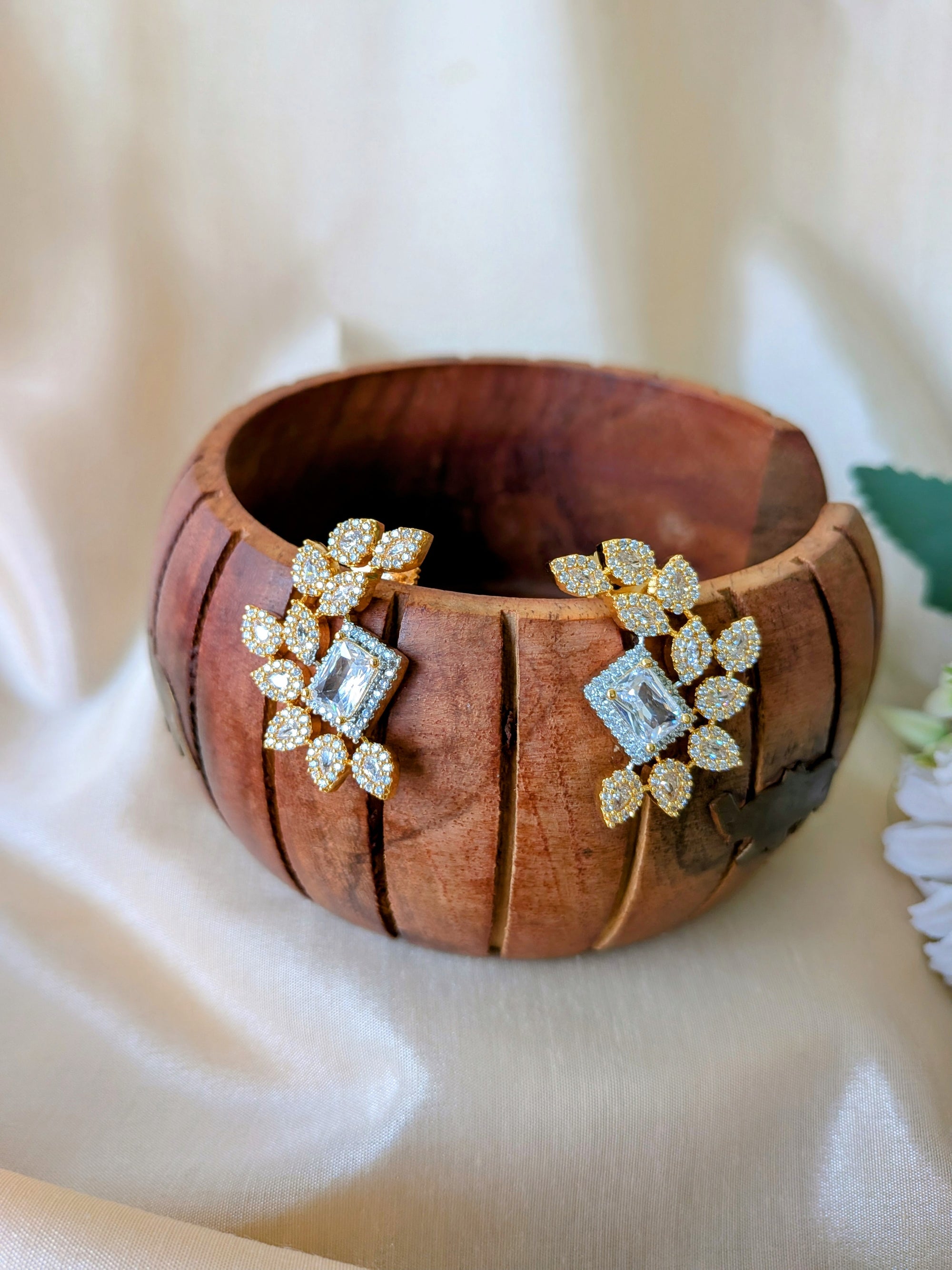 Regalia Bloom Studs – emerald-cut white stone stud surrounded by zirconia halo in gold setting