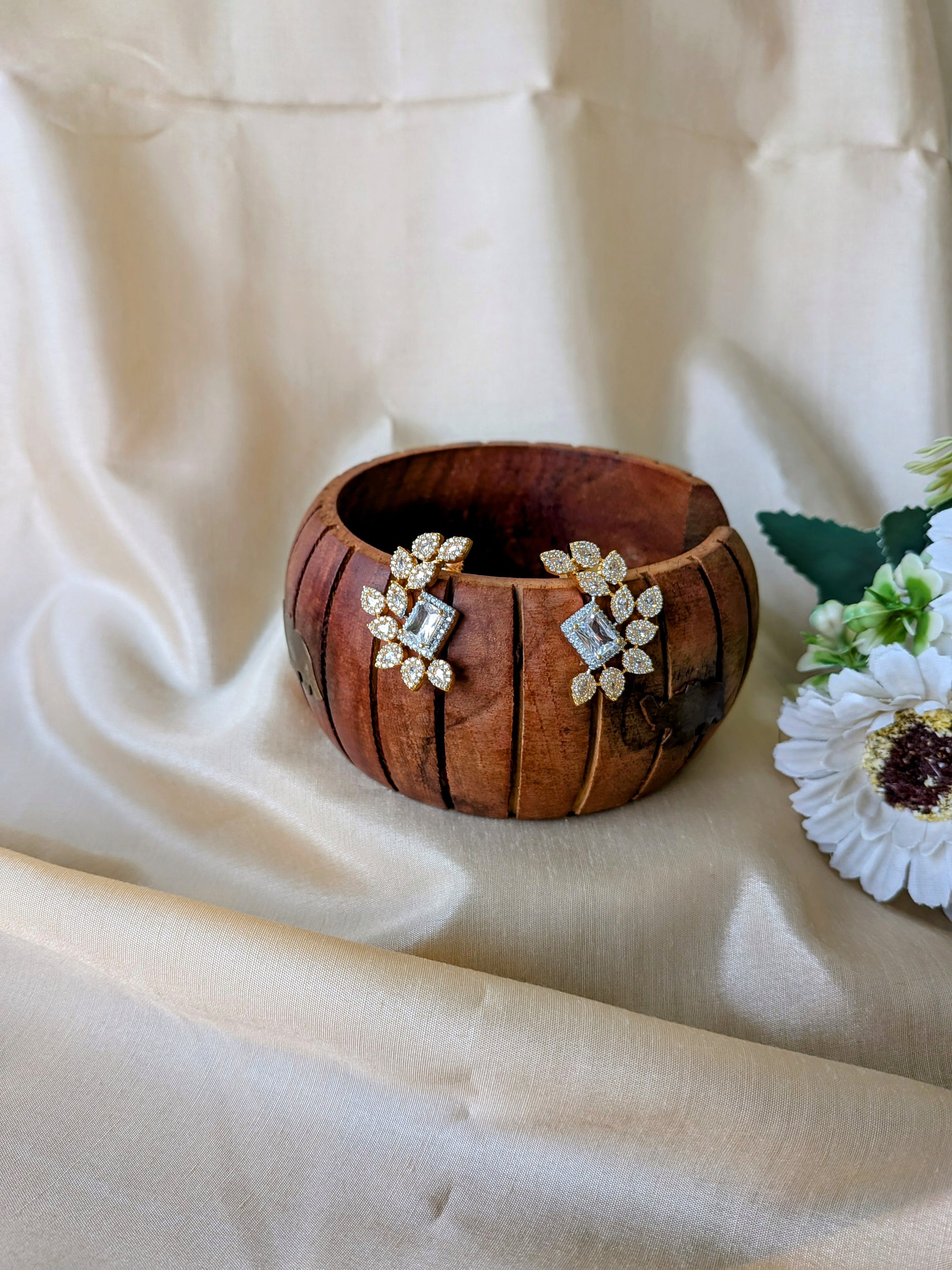 Regalia Bloom Studs – emerald-cut white stone stud surrounded by zirconia halo in gold setting
