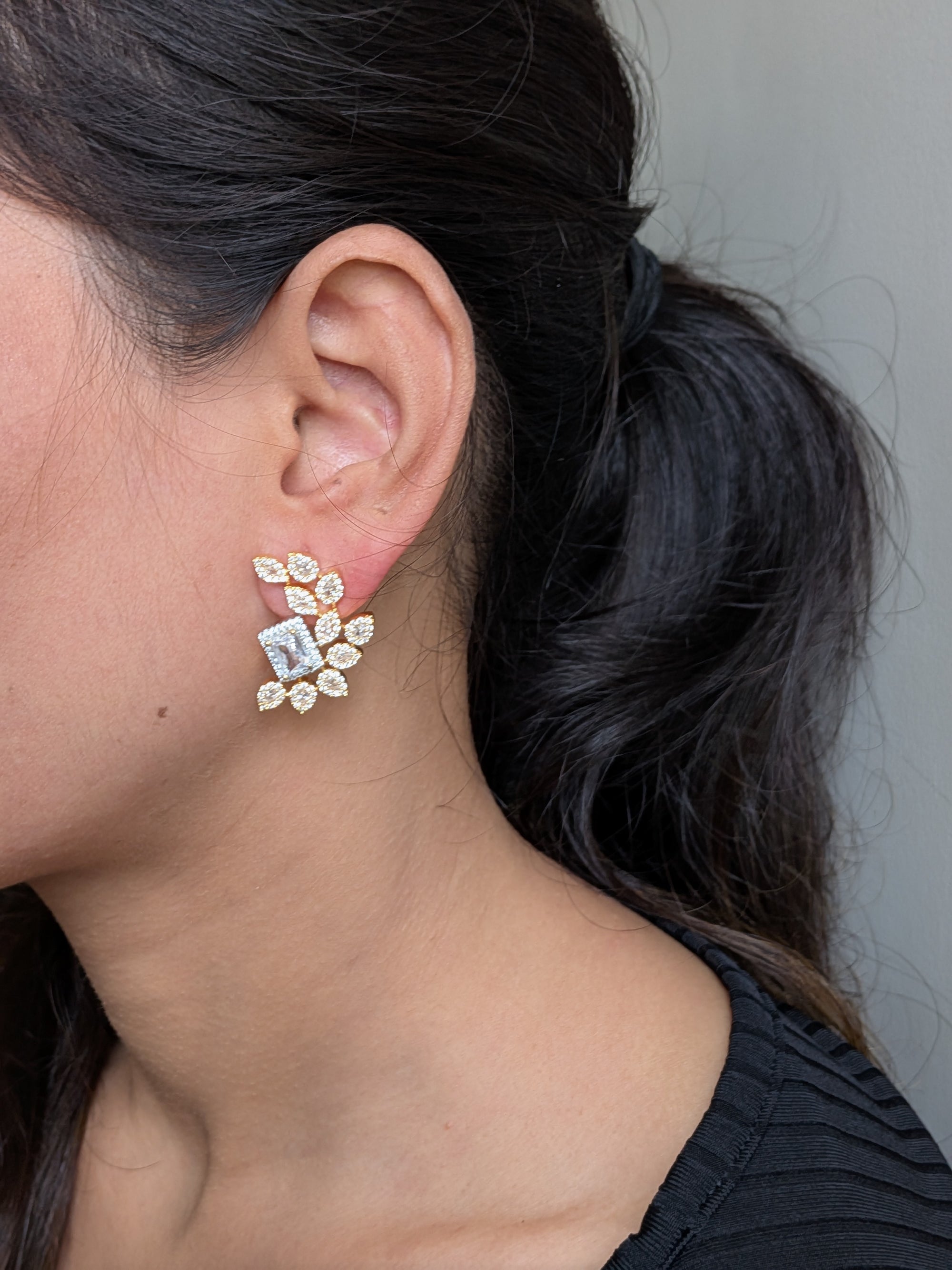 Regalia Bloom Studs – emerald-cut white stone stud surrounded by zirconia halo in gold setting
