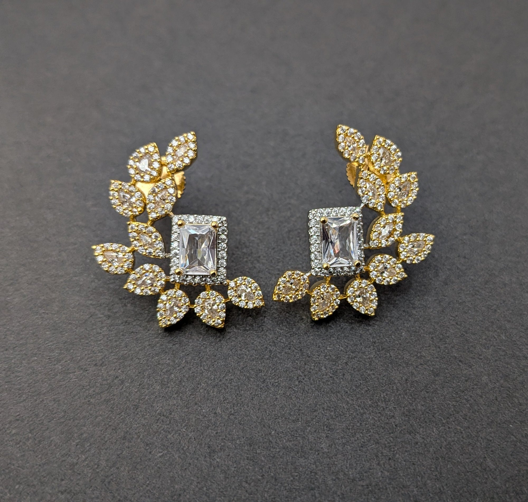 Regalia Bloom Studs – emerald-cut white stone stud surrounded by zirconia halo in gold setting