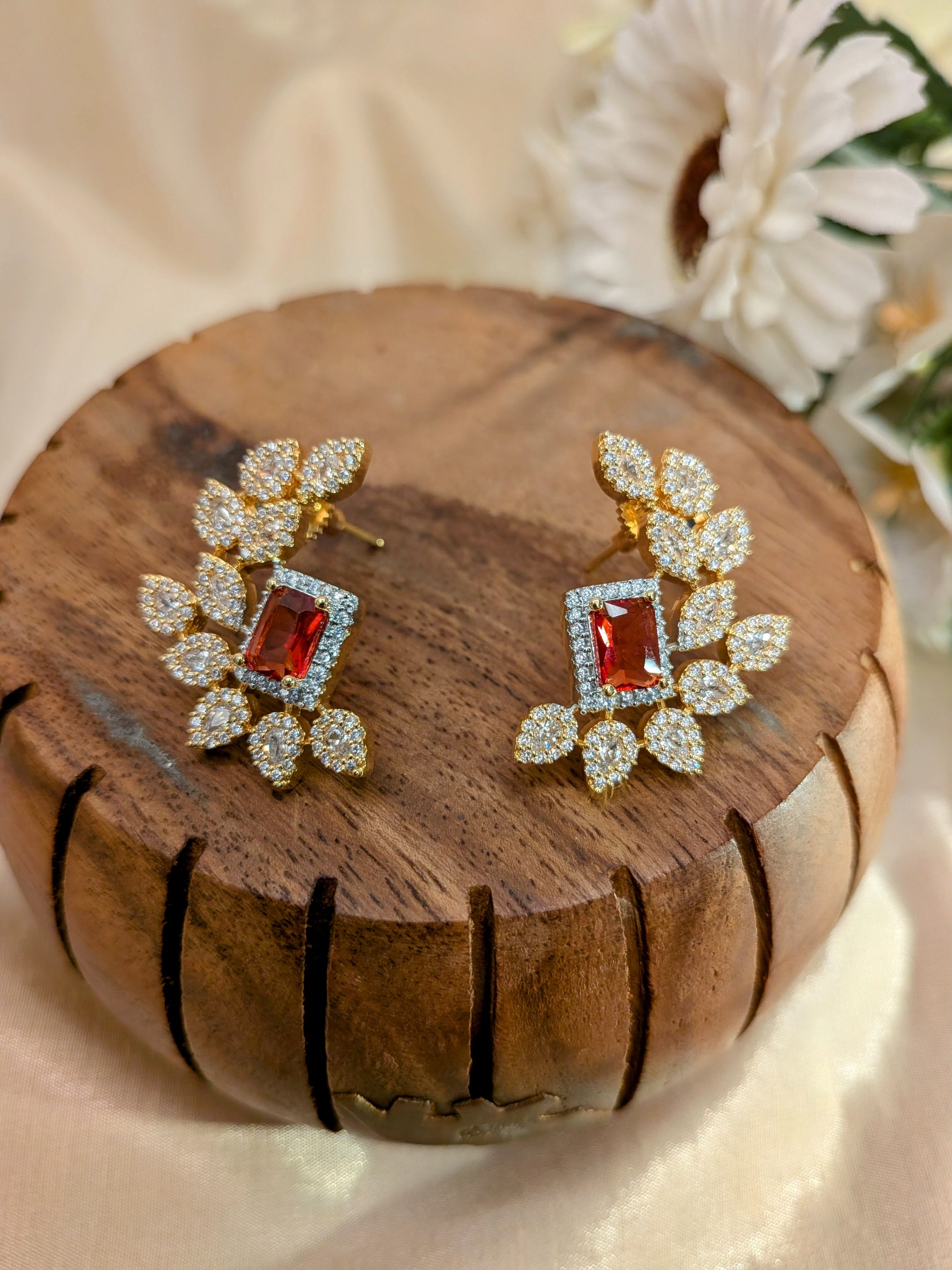 Regalia Bloom Studs – emerald-cut white stone stud surrounded by zirconia halo in gold setting